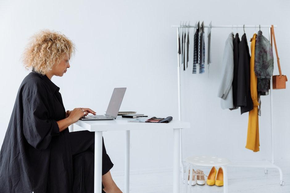 Woman in Black Dress Using Laptop