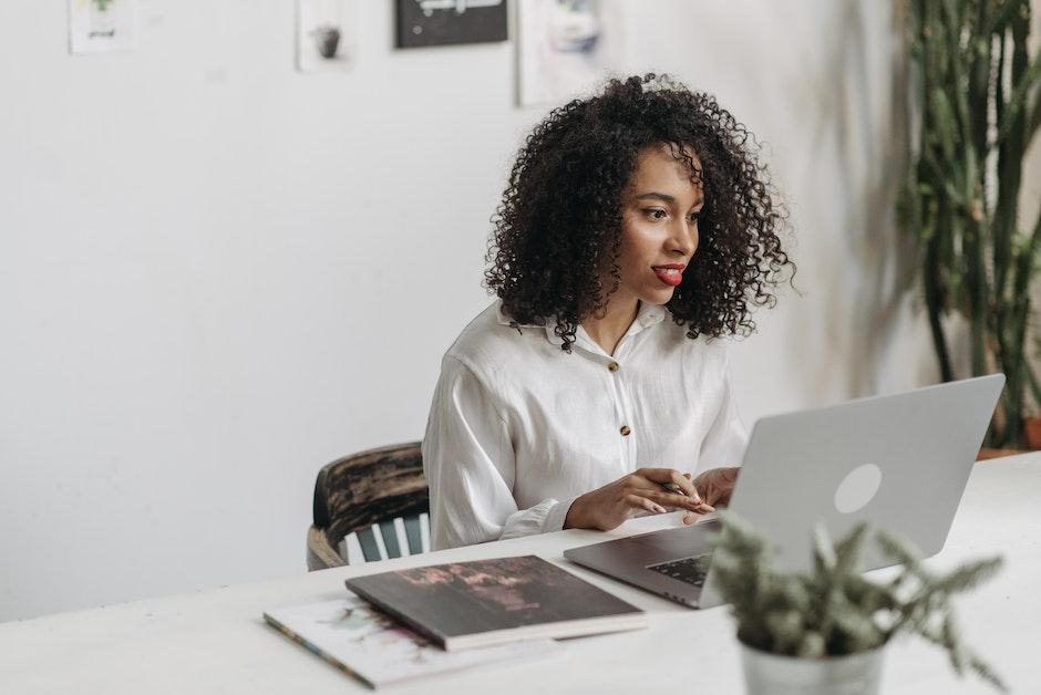 A Woman with Curly Hair using Laptop