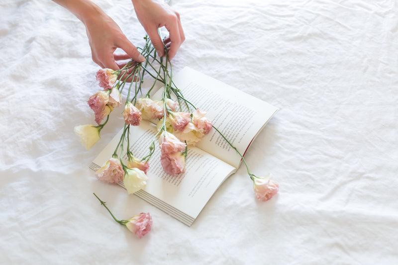 bedsheet, flowers & hands