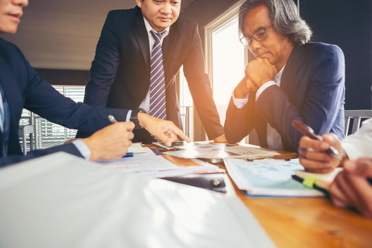 Image of business people hands working with papers at meeting. Businessman holding pens and holding 